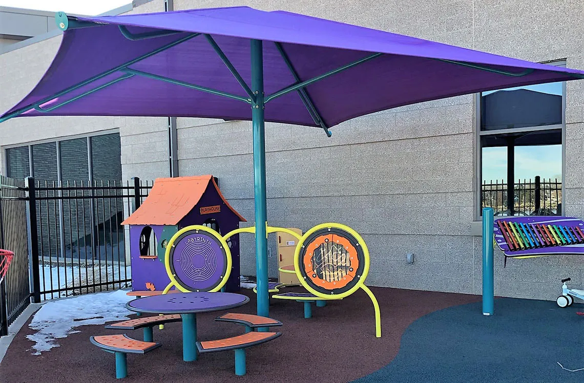 Shaded outdoor musical playground at Broomfield Community Center in Broomfield, CO